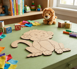 Children's play area with MDF DIY monkey cutout, colorful blocks, and toys on a green table.