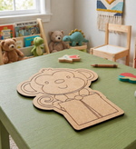 Children's play area with MDF DIY monkey cutout on a green table, surrounded by toys and books.
