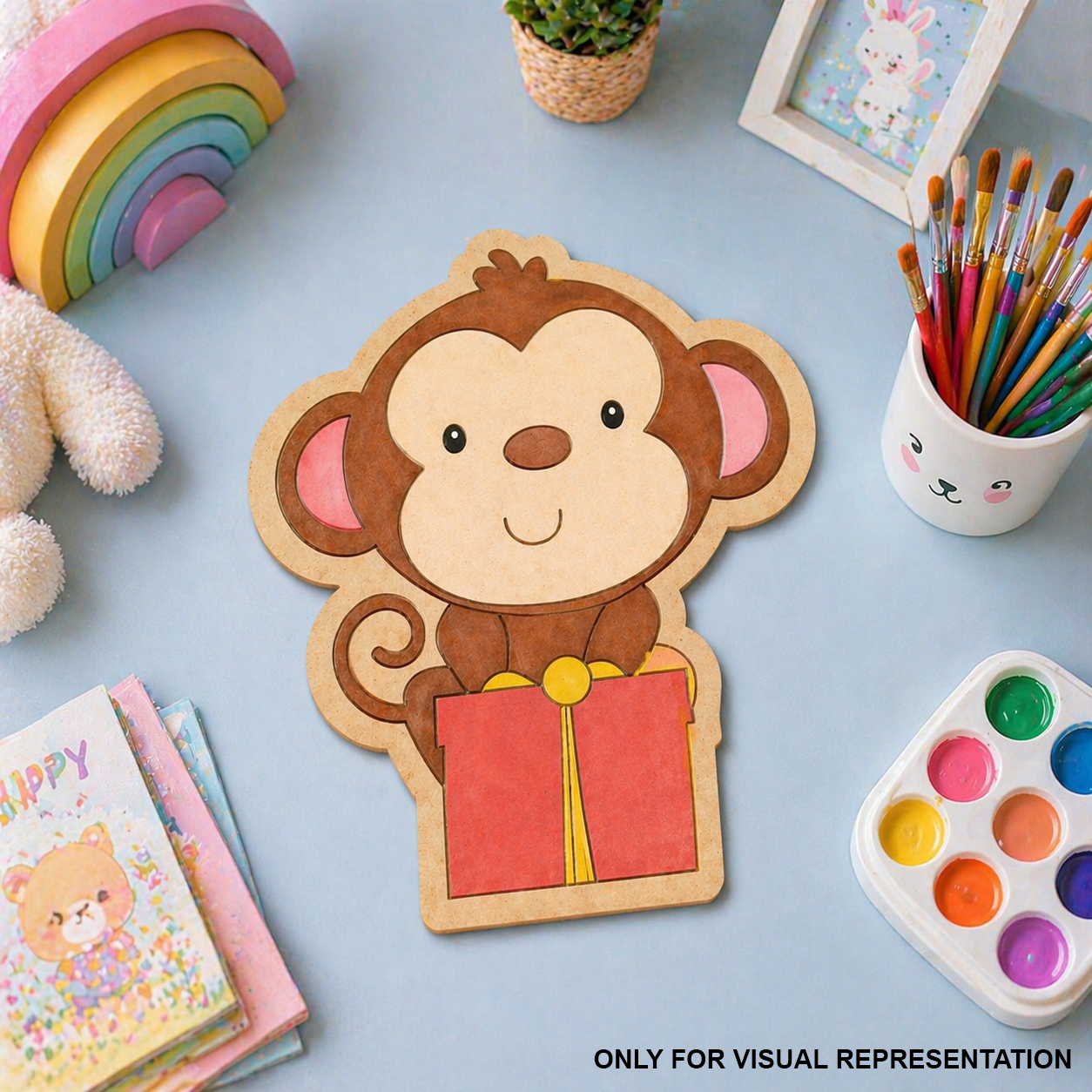 MDF DIY  toy monkey with a book on a light blue surface with stationery items.