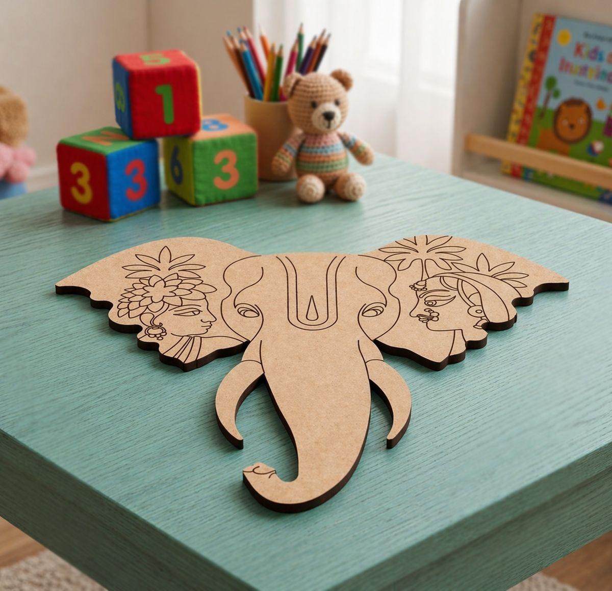 MDF DIY  elephant head cutout on a green table with colorful blocks and a teddy bear in the background.