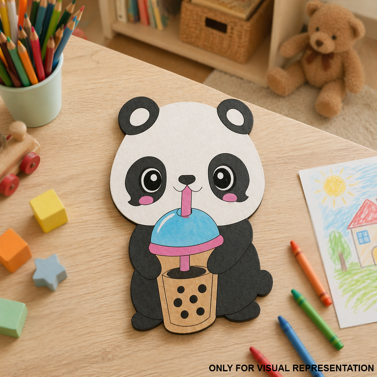 Children's craft project of a MDF DIY panda holding a cup with a straw on a wooden table with coloring supplies.