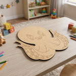 MDF DIY  craft shaped like a ghost on a table with toys and books in the background