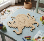 MDF DIY octopus cutout on a child's table with toys and books around