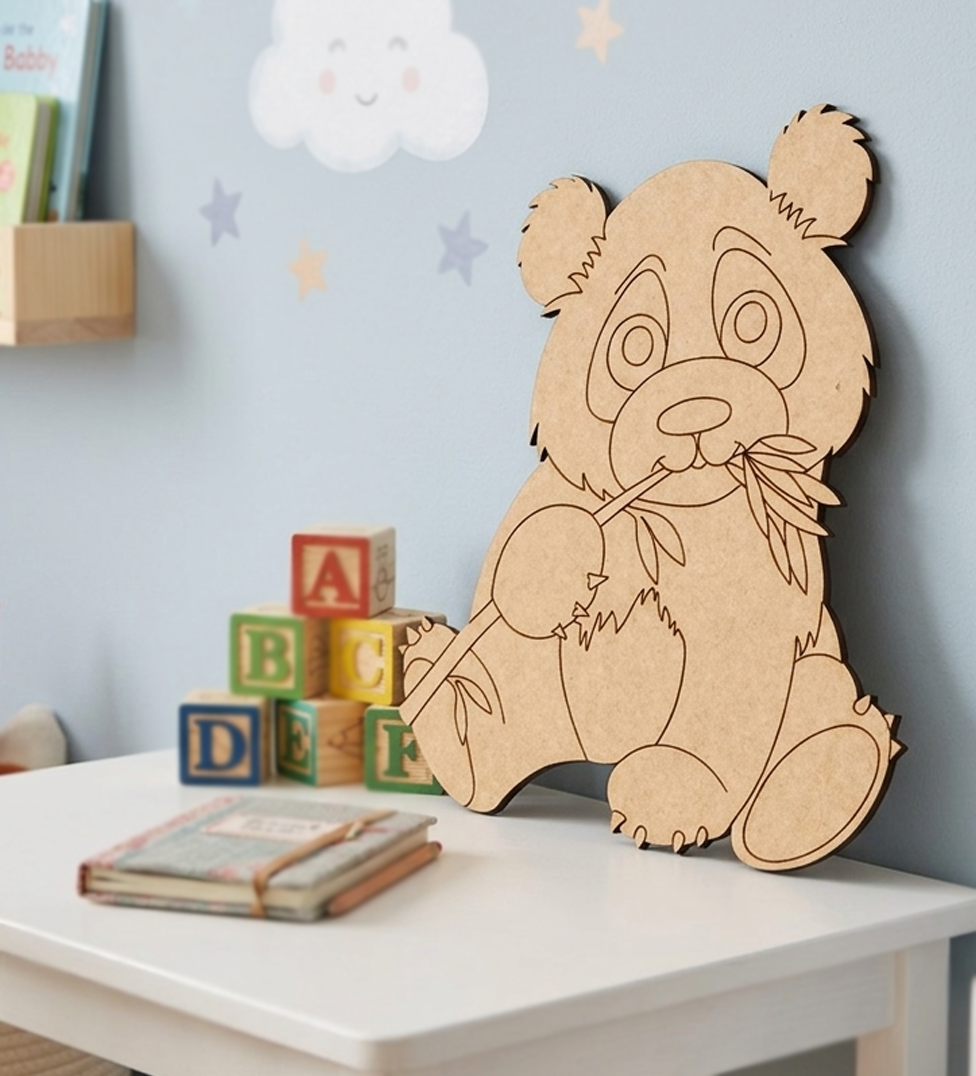 MDF DIY panda decoration on a table with children's books and blocks in a room.