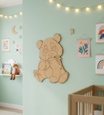 MDF DIY panda wall decoration in a child's room with light green walls and colorful artwork.