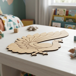 MDF DIY peacock cutout on a table with children's books and toys in the background