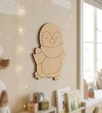 DIY MDF  penguin wall decoration in a child's room with toys and books.
