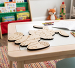 Children's DIY MDF  cutout of a bunny on a table with coloring books and crayons in the background.