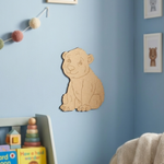 DIY MDF  bear decoration on a blue wall with children's toys below