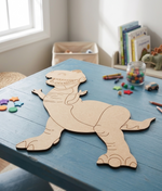 DIY MDF  dinosaur cutout on a blue table with children's toys in the background
