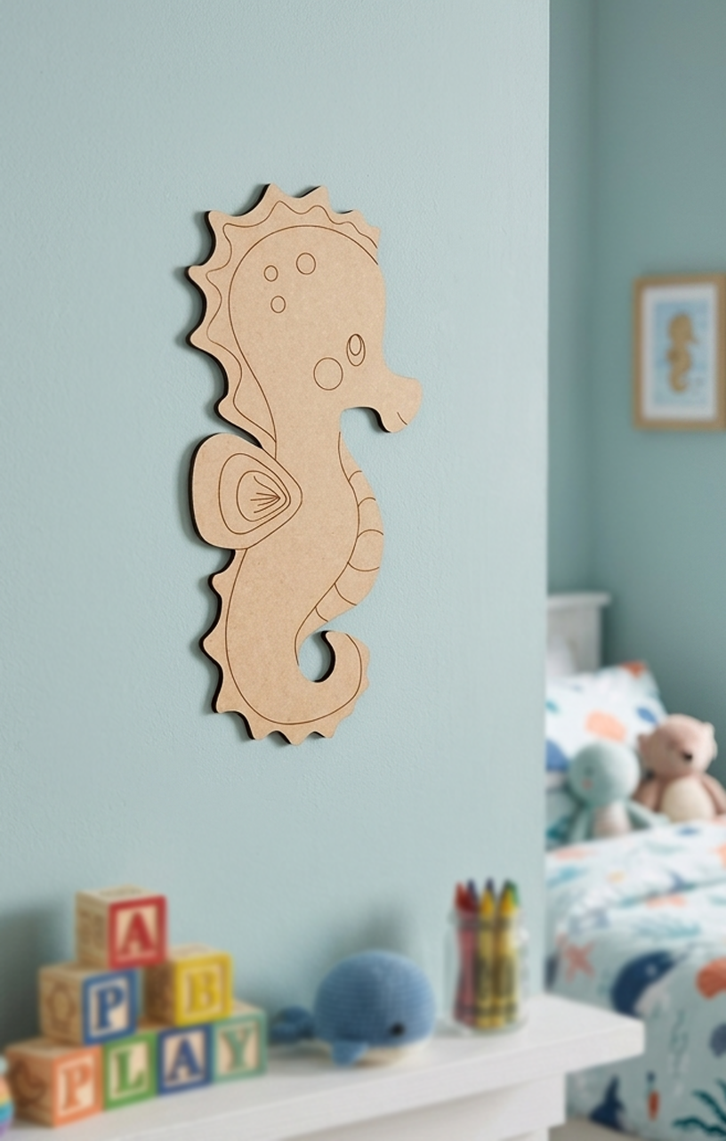 DIY MDF  seahorse wall decoration in a child's room with toys and blocks.