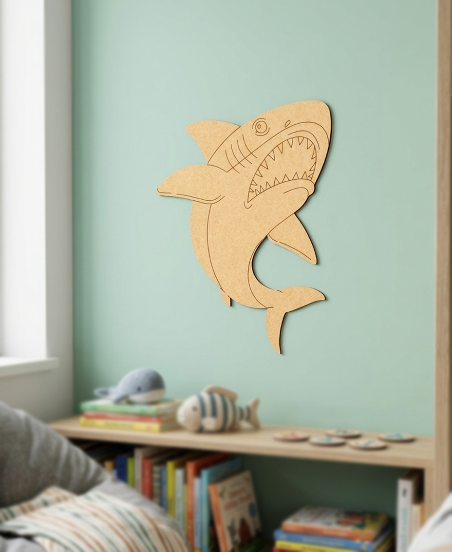DIY MDF  shark wall decoration on a light green wall with books and toys below.