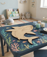 Children's room with a table featuring a DIY MDF shark cutout and art supplies.