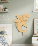 DIY MDF  shark wall decoration in a child's bedroom with light green walls and shelves.
