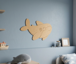 DIY MDF  shark wall decoration on a blue wall with toys and a picture frame in the background.