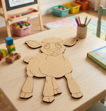 DIY MDF  sheep cutout on a children's play table with toys and books in the background