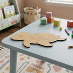 DIY MDF  turtle puzzle on a children's table with toys in the background