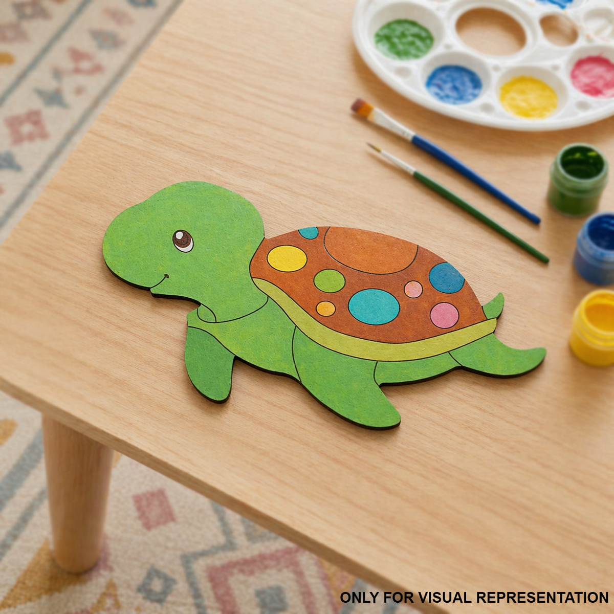 Colorful DIY MDF  turtle on a wooden table with paint supplies