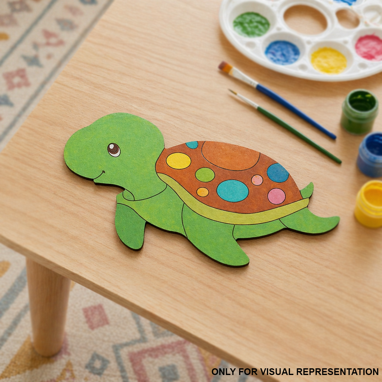 Colorful DIY MDF  turtle on a wooden table with paint supplies