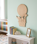 MDF DIY  wall decoration of a hot air balloon with animals on a light green wall.