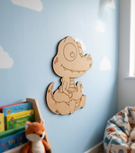MDF DIY crocodile wall decoration in a child's room with books and a bean bag chair.