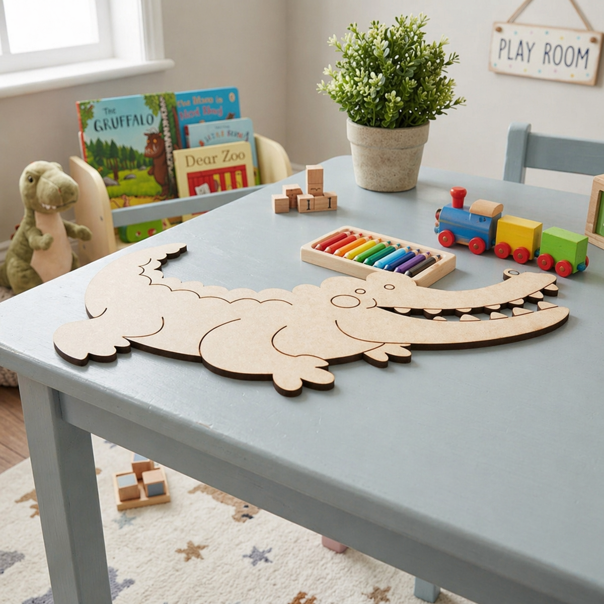 Children's playroom with a table featuring a MDF DIY  alligator puzzle, colorful train, and books.