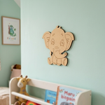 MDF DIY  elephant wall decoration in a child's room with toys and books.