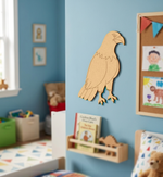 MDF DIY  eagle decoration on a blue wall in a child's bedroom with books and toys.
