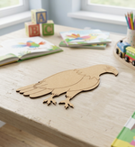 MDF DIY  bird cutout on a children's table with books and toys in the background.