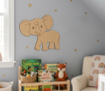 Children's room with a wall decal of an MDF DIY  elephant, books, and a plush toy on a shelf.