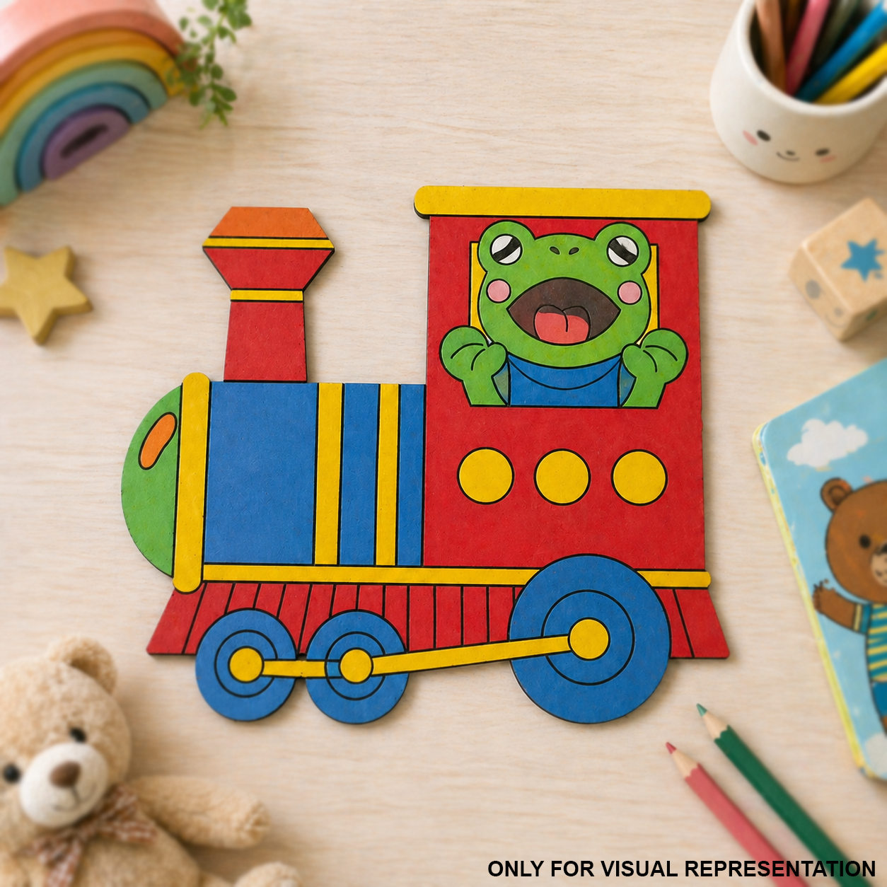 MDF DIY  Colorful train-shaped cutout with a frog character on a wooden surface with toys and stationery.