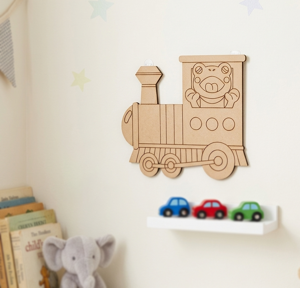 MDF DIY  train-shaped toy with a bear face on a wall above children's books and toys.