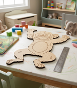 DIY MDF monkey Cutout on a children's table with toys and books in the background
