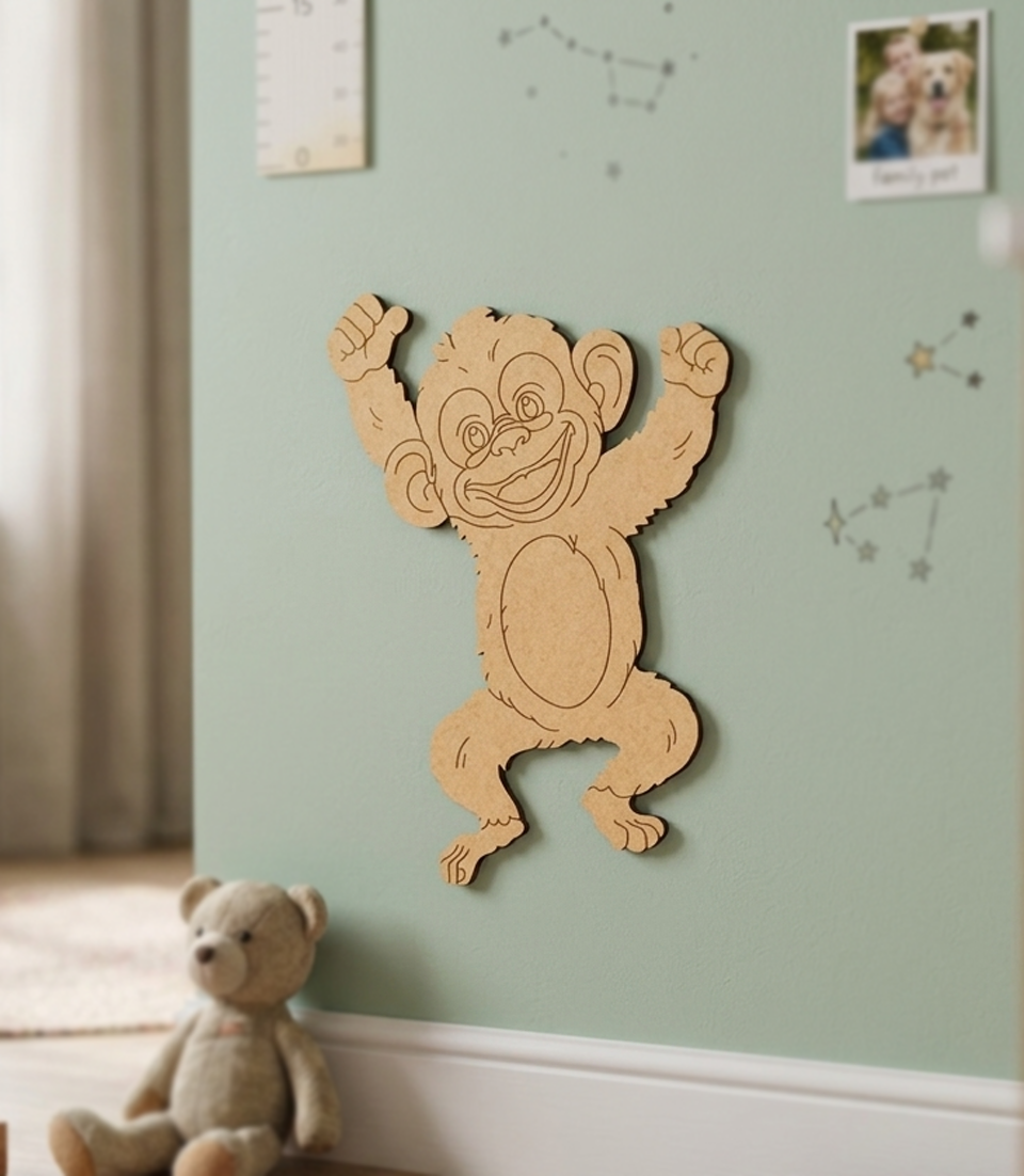 DIY MDF  monkey wall decoration on a light green wall with a teddy bear in the foreground.