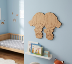 DIY MDF hot air balloon wall decor in a child's bedroom with books and a fox toy.
