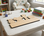 DIY MDF cutout with animal figures on a table in a child's playroom.