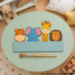 DIY MDF Colorful animal-shaped wooden toys on a green surface with a brush, surrounded by children's toys and items.