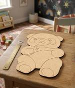 DIY MDF  panda cutout on a table with a ruler next to it in a child's playroom.