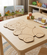 DIY MDF panda cutout on a table with educational materials in the background