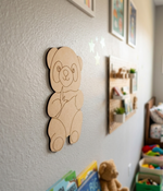 DIY MDF panda  decoration on a wall in a child's room with toys and books.
