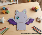 DIY MDF Children's craft project of a bat on a wooden table with colorful pencils and blocks.