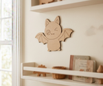 DIY MDF  bat wall decoration on a white wall with shelves below