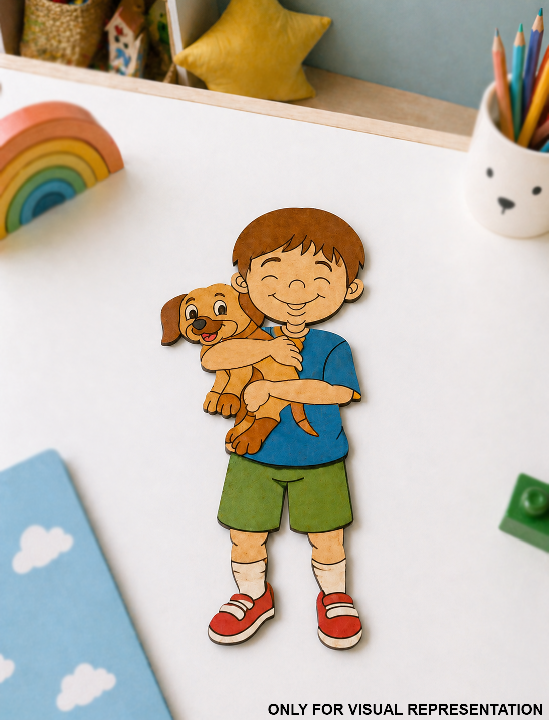 DIY MDF  toy figure of a boy holding a dog on a white surface with colorful toys in the background.