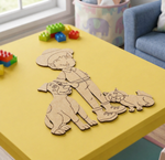 MDF DIY Cartoon cutout of a boy with two dogs on a yellow table with colorful building blocks in the background.