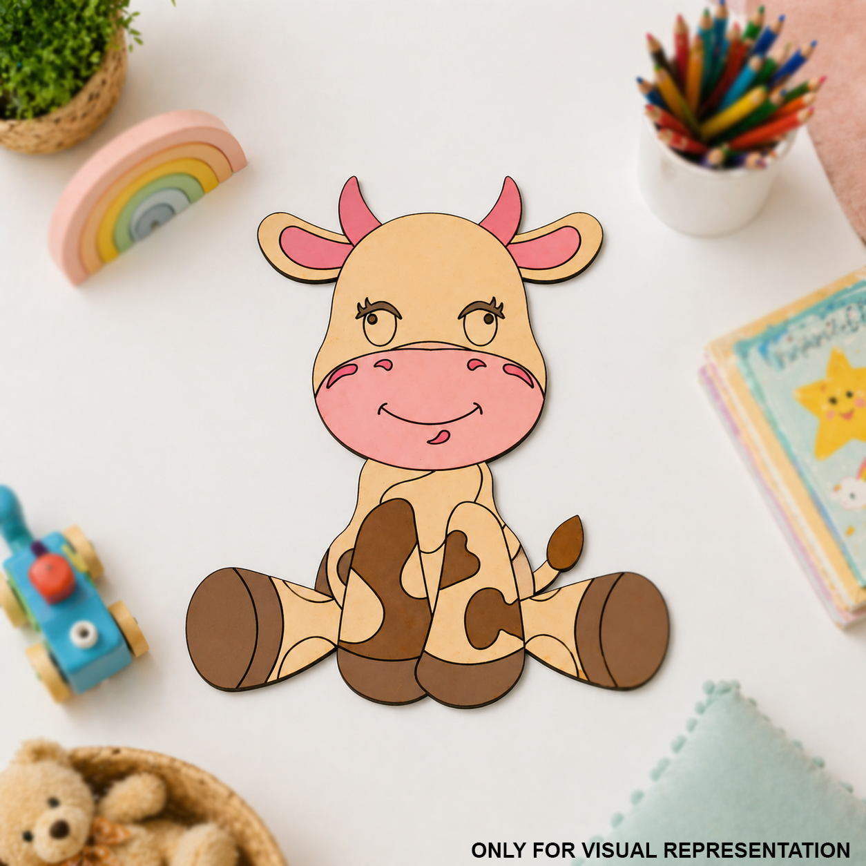 MDF DIY Cartoon cow cutout on a white surface with colorful pencils and toys around