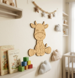 MDF DIY cow wall decoration in a child's room with books and toys.