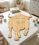 MDF DIY bull puzzle on a table with toys and books in the background