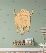 MDF DIY bull wall decoration on a light green wall with children's toys below.