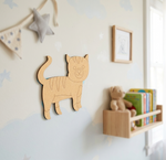 MDF DIY cat-shaped wall decoration in a child's room with books and a teddy bear.