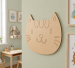 MDF DIY cat face cutout on a wall.